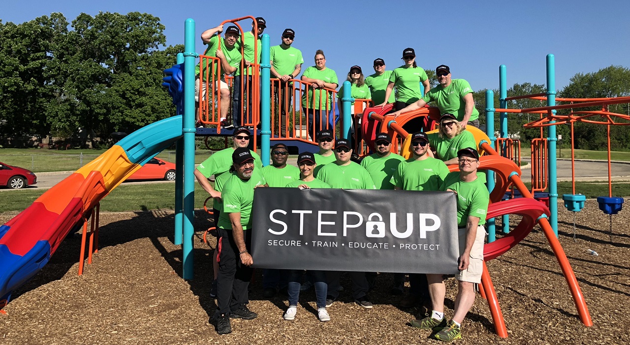 Colleagues pose on a playground