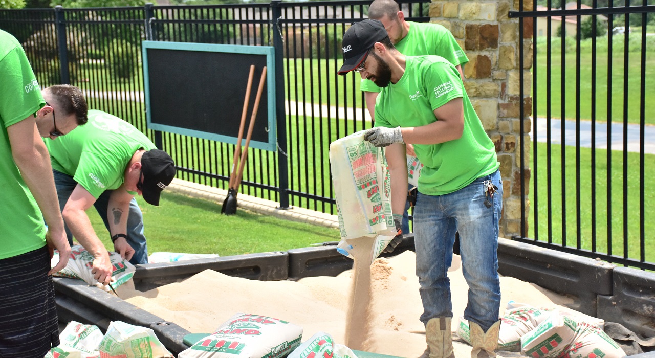 Colleagues creating a sandbox in a playground