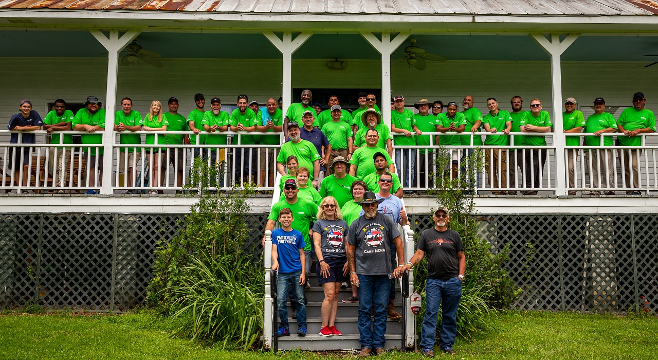 Colleagues posing in front of their work site
