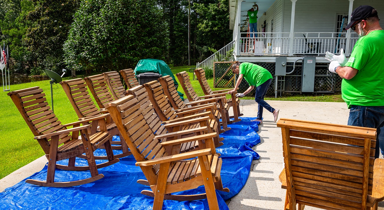 Colleague re-varnishing chairs