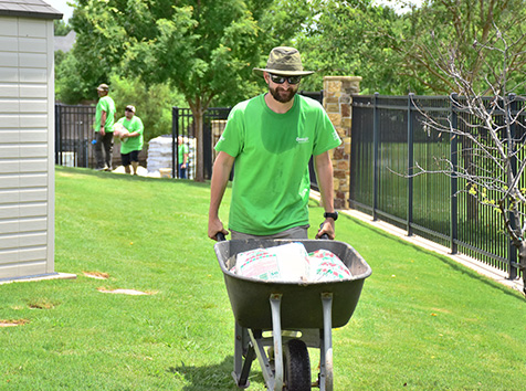 Man pushing wheelbarrow