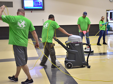 People cleaning a gym floor