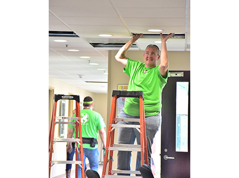 Person moving a roof tile