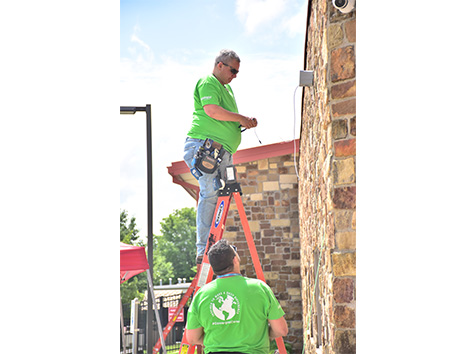 Man installing security camera