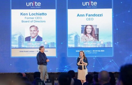 Three people smiling on stage