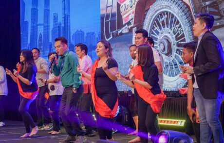 Eight people smiling on stage for a picture