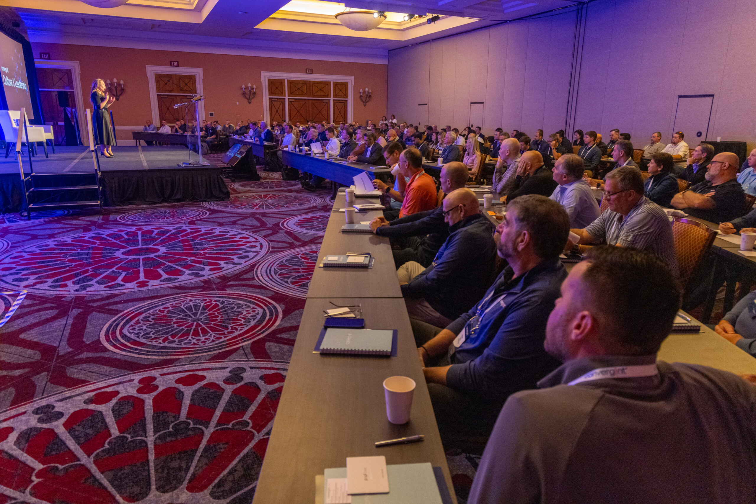 A group of people sitting in a room watching a presentation